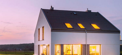 single family home at dusk with the interior lights on