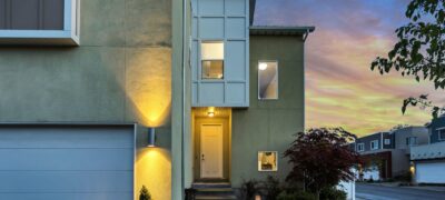 single family rental home with the porch light on