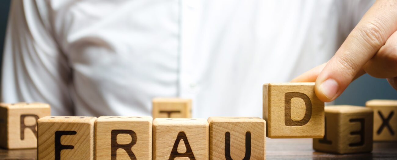 man assembles letter blocks spelling out the work 