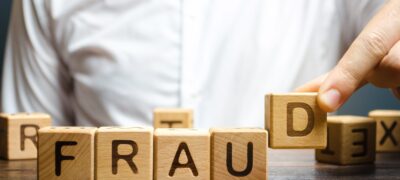 man assembles letter blocks spelling out the work 