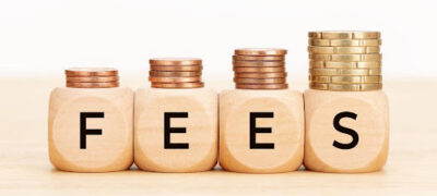 Junk Fees for Renters represented with stacks of coins on wooden blocks