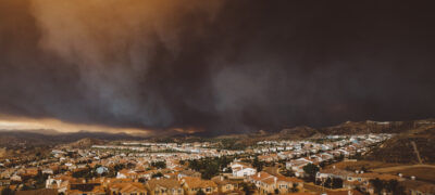 The smoke from Los Angeles wildfire Santa Clarita cityscape at sunset in California