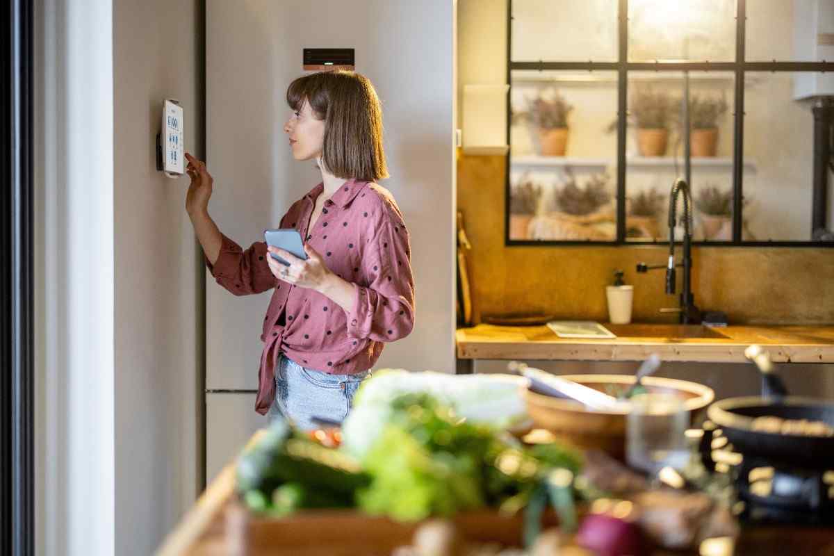 Resident adjusting smart home thermostat